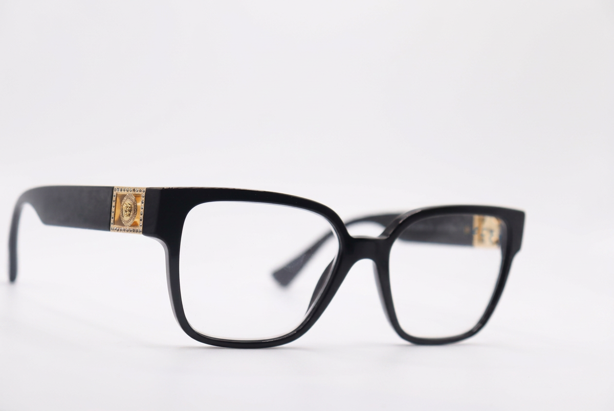 Black eyeglasses with gold temple details, front angle on a white background