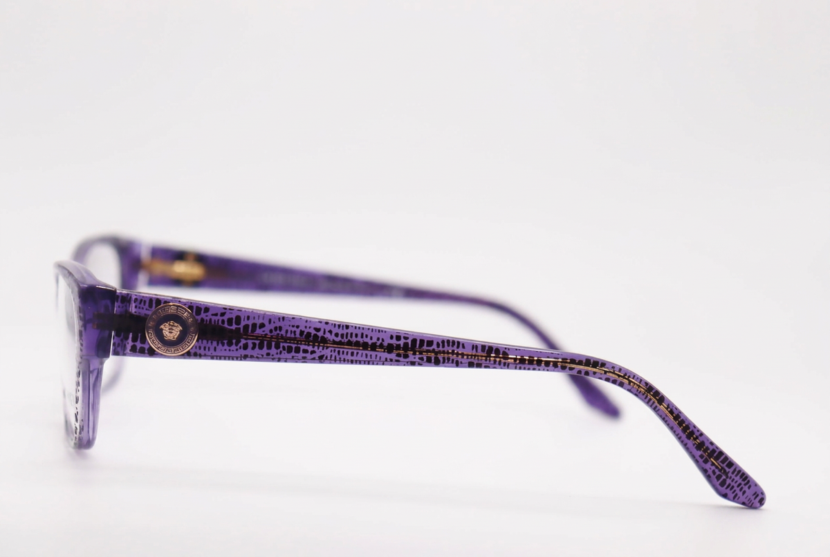 Purple patterned Versace eyeglasses, side view on white background