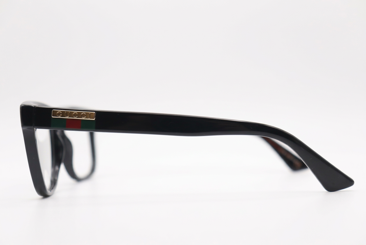 Black Gucci eyeglasses side view on a white background